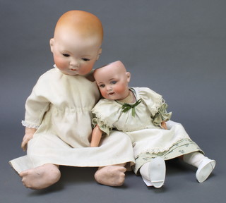 Armand Marseille a porcelain headed doll with sleep eyes, head incised AM Germany 34/8.K with articulated limbs 19" (fingers damaged) together with 1 other porcelain headed doll with sleep eyes (f), open mouth with 2 teeth, incised AM Germany 990A.3.M 16 1/2" 