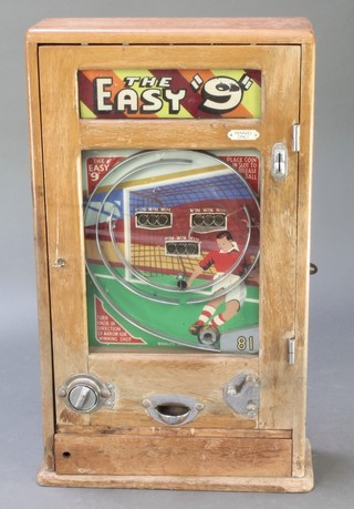 A 1940's/50's "The Easy 9" wall mounted football game contained in an oak case 32"h x 17 1/2" x 6" 