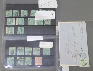 21 Victorian green 1 shilling stamps, 1 other 1 shilling stamp, a stamped envelope 