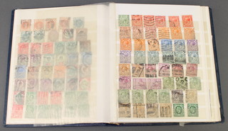 A blue stock book of GB used stamps - Victoria to Elizabeth including tuppenny reds
