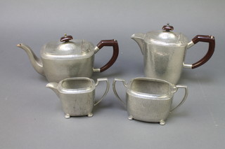 A planished pewter rectangular 4 piece tea service comprising teapot, hot water jug, cream jug and  sugar bowl with bakelite handles