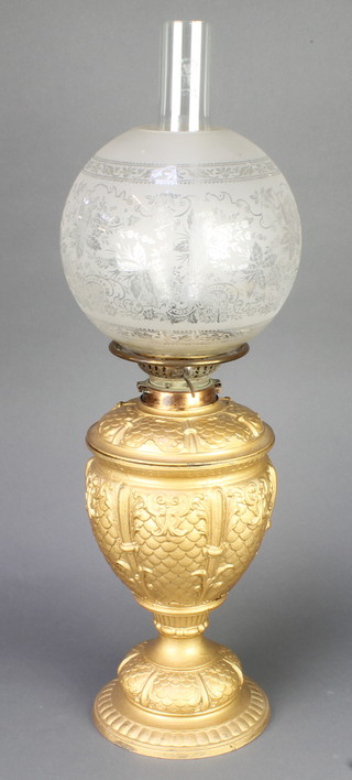 A Victorian gilt painted spelter oil lamp with etched glass shade and chimney 