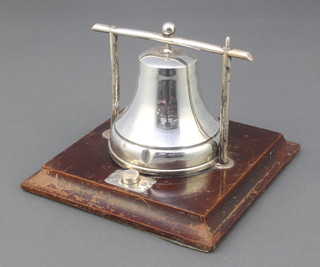 An Edwardian silver desk bell with button start, on a wooden plinth 4" 