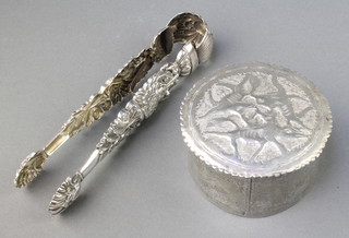A pair of Continental repousse silver sugar nips with swan stems and shell bowls, a Continental white metal box 