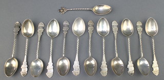 A matched set of 12 fancy silver coffee spoons with spiral stems and bright cut handles, Birmingham 1897 and London 1936, a silver coffee spoon, 148 grams