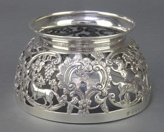 An Edwardian pierced silver bowl stand with dogs and birds amongst flowers, having an engraved cartouche, London 1911, 130 grams