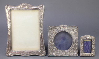 An Edwardian repousse silver photograph frame Birmingham 1903 4" and 2 others