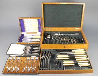 An oak canteen containing a set of silver plated cutlery for 6 and 3 other cased sets