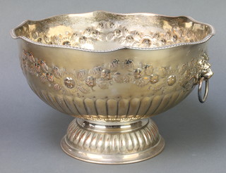 A circular silver plated punch bowl with floral decoration and lion ring handles 13" 