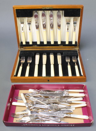 A walnut canteen containing a set of silver plated fish eaters for 8, minor cutlery 
