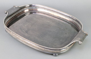 A silver plated galleried 2 handled tray on ball feet 24" 