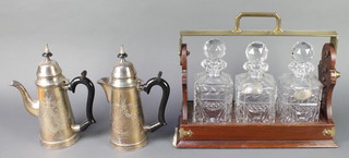 A modern 3 bottle tantalus and a pair of silver plated Queen Anne style coffee pot and hot water pot 