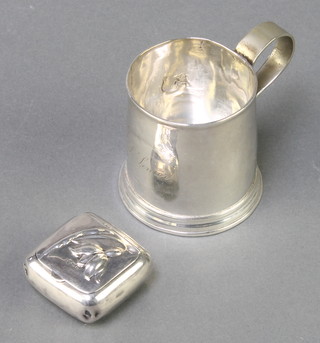 A Continental silver pill box with floral decoration, import marks London 1900, a silver mug 