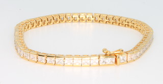 A silver gilt gem set tennis bracelet