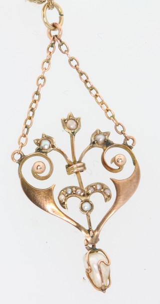 An Edwardian 9ct yellow gold baroque and seed pearl pendant on a ditto chain 