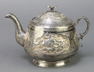An Indian repousse silver baluster teapot decorated with panels of hunting scenes 314 grams