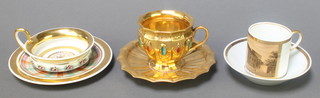 A 19th Century gilt "gem" set cabinet cup and saucer, a ditto with townscape and another with tartan and floral decoration 