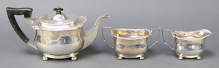 A silver 3 piece tea set with scroll and egg and dart rim, having ebony mounts, Sheffield 1913 and 1914, gross 928 grams