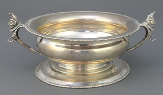 A silver 2 handled bowl with egg and dart rim and Mr Punch mask handles, Sheffield 1911, 237 grams