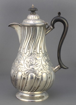 A Victorian repousse silver coffee pot with demi-fluted and scroll decoration having ebony mounts Sheffield 1891, 506 grams 10"  