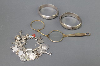 2 silver bangles, a ditto charm bracelet and a pair of gilt lorgnettes