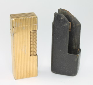 A gentleman's gilt cased ribbed Dunhill cigarette lighter in a Dunhill leather pocket