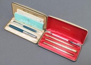 A cased blue Parker 51 fountain pen and pencil, a gold plated Parker pen set comprising fountain pen, roller ball and propelling pencil