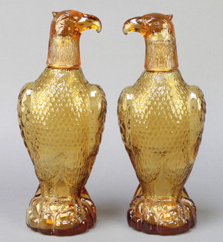 A pair of amber glass decanters in the form of seated eagles 11" 