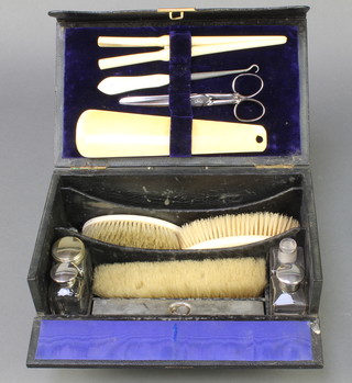 An Edwardian leather bound toilet box with bone accessories 