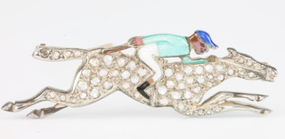 A yellow gold diamond and enamel brooch in the form of a jockey up
