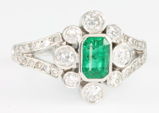 An 18ct white gold Edwardian style emerald and diamond ring with open mount, size M 1/2
