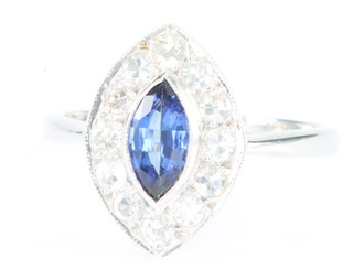 An 18ct white gold elliptical sapphire and diamond ring, the centre stone approx. 0.65ct, surrounded by brilliant cut diamonds, approx 0.5ct, size N 1/2