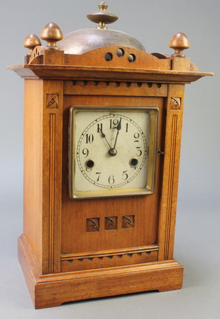 Hamburg American Clock Company, a 14 day Art Nouveau striking mantel clock with square silvered dial and Arabic numerals contained in a walnut case, having bell to the top 