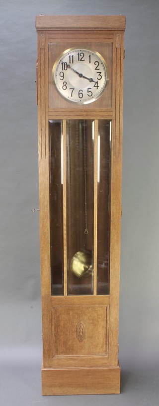 A 1920's Art Deco 8 day chiming longcase clock with 11" dial, striking on a gong, labelled to the interior Wilh Devin, contained in an oak case 83"h  