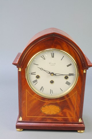 Comitti of London, a Georgian style chiming bracket clock with enamelled dial and Roman numerals, contained in an arch shaped inlaid mahogany case 