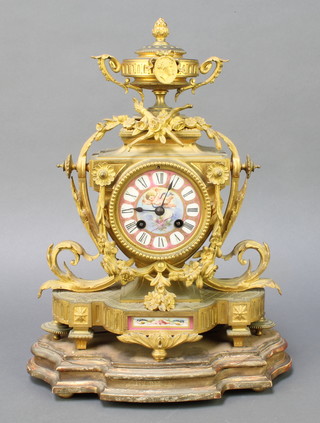 LeRoy & Fils, a French 19th Century striking mantel clock with Sevres style plaque and porcelain dial, the dial with Roman numerals, contained in a gilt ormolu case surmounted by a lidded urn, marked LeRoy & Fils Paris 13070