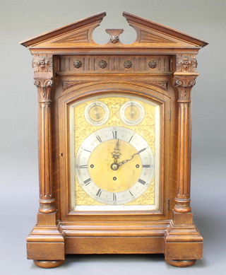 An Edwardian triple fusee Grand Sonnerie bracket clock with 7 1/2" gilt arched dial, silvered chapter ring, Roman numerals, chime/silent indicator and Whittington/Cambridge chimes indicator, striking on 8 bells and gong, contained in a carved oak case 