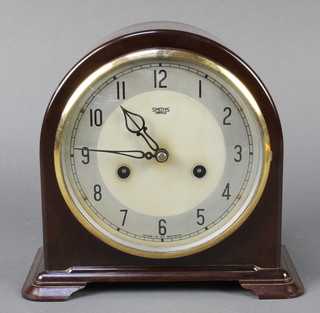 An Art Deco Smiths Enfield chiming mantel clock with silvered dial and Arabic numerals contained in an arched brown Bakelite case 