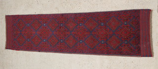 A Meshwani blue and red ground runner with 18 diamonds to the centre 102" x 35"  