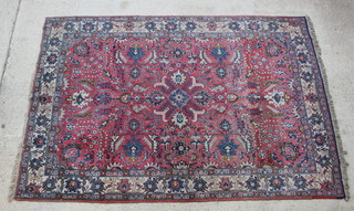 A Persian Tabriz pink ground and floral patterned carpet 122" x 82" 