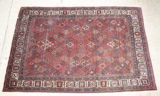 A brown and blue ground Persian Joshaghan carpet 130" x 88"