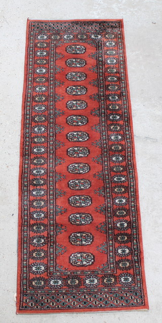 A tan ground Bokhara runner with 14 octagons to the centre 73" x 24" 