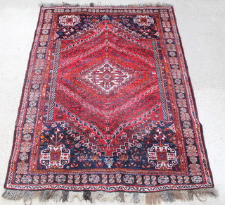 A red ground Persian Qashqai carpet with central medallion 98" x 71 1/2" 
