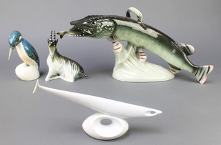 A Royal Dux figure of a Kingfisher 7", a ditto of a seated goat 6 1/2", a stylised figure of a white glazed fish 11" and a figure of a trout swallowing a fish 20" 