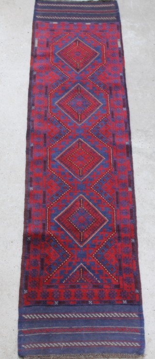 A red and blue ground Meshwani runner with 4 diamonds to the centre 99" x 23 1/2"