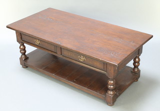 A rectangular oak 2 tier coffee table fitted 2 frieze drawers, raised on turned and block supports with undertier 18 1/2"h x 48"w x 24"d 