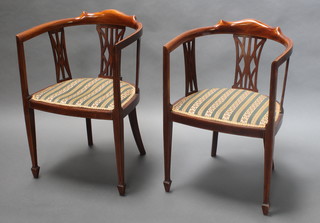 A pair of Edwardian inlaid mahogany tub back dining chairs with upholstered seats on square tapering supports, spade feet 