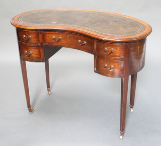An Edwardian inlaid mahogany kidney shaped writing table with inset green leather writing surface fitted 1 long drawer flanked by 4 short drawers, on square tapered supports, brass caps and casters 29"h x 39"w x 17 1/2"d 