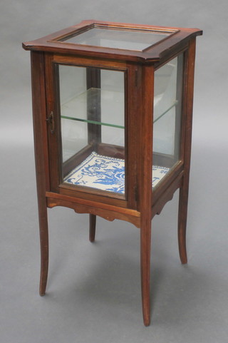 An Edwardian Art Nouveau inlaid mahogany pedestal display cabinet enclosed by a panelled door, raised on square tapered supports 30 1/2"h x 15"w x 15"d 