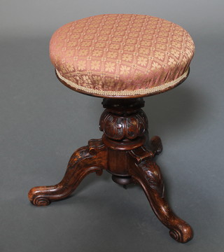 A Victorian carved walnut adjustable piano stool raised on pillar and tripod supports 18" x 14" 